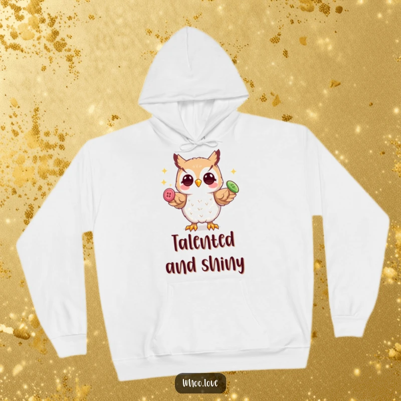 Funny playful owl hoodie, cozy and warm, featuring an owl skillfully juggling three shiny buttons with its talons.