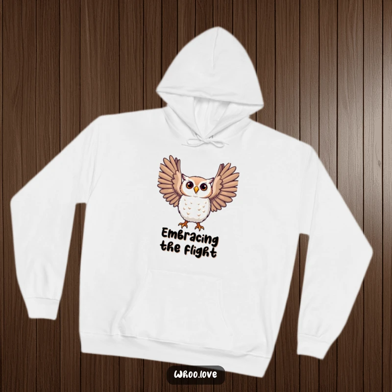 Funny owl hoodie, a character joyfully stretching large, expressive wings, soft and warm apparel for comfort.