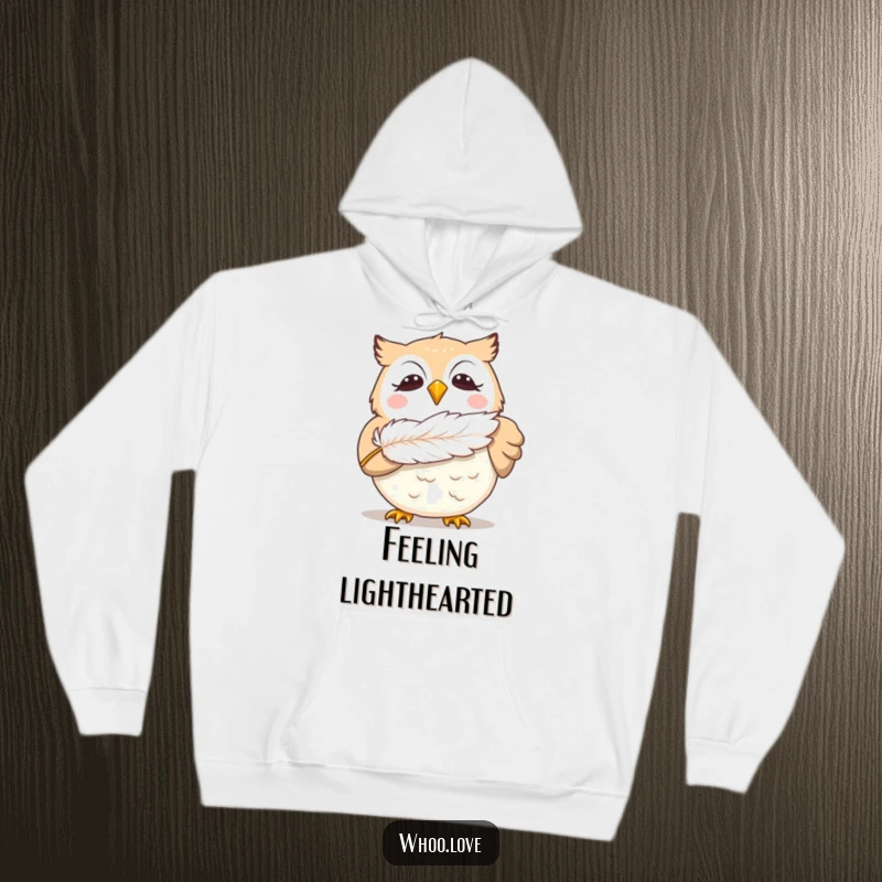 Funny giggling owl hoodie, showing a delighted owl blowing a feather, offering warmth and a humorous, joyful design for owl enthusiasts.