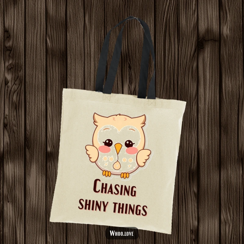 Funny tote bag with a happy owl playfully dropping a small, shiny object, perfect for carrying essentials with a smile.